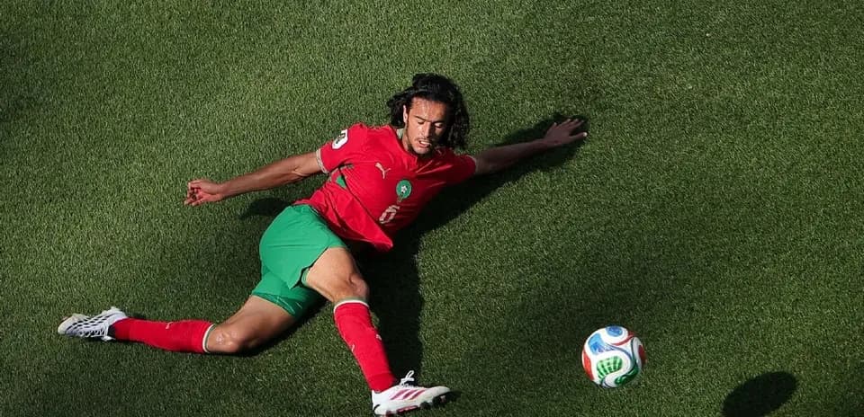 Player from Morocco sliding on the grass field