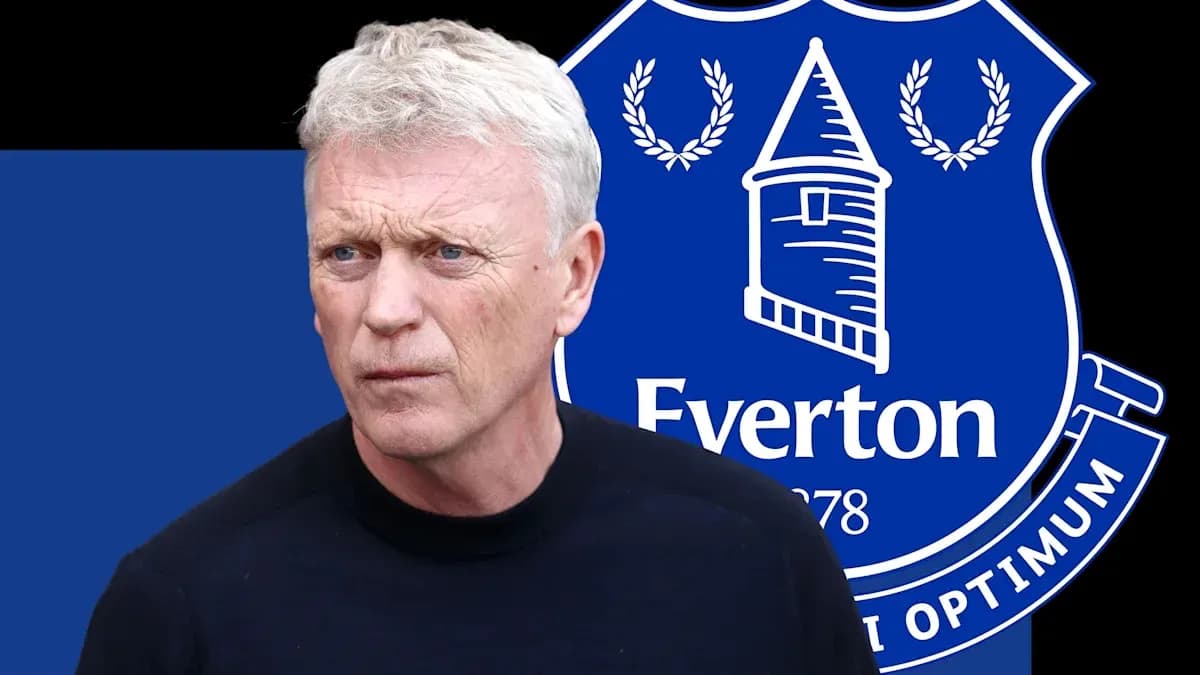 Manager in front of Everton logo background