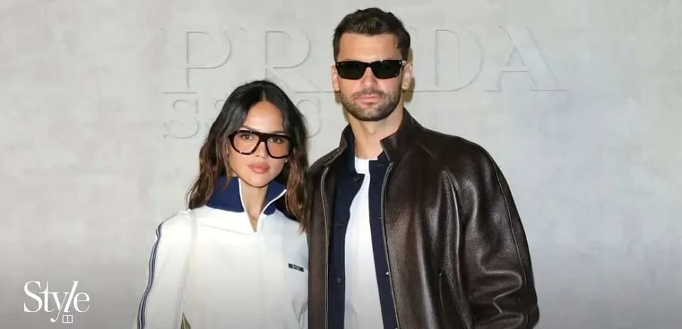 Couple posing in stylish outfits at event