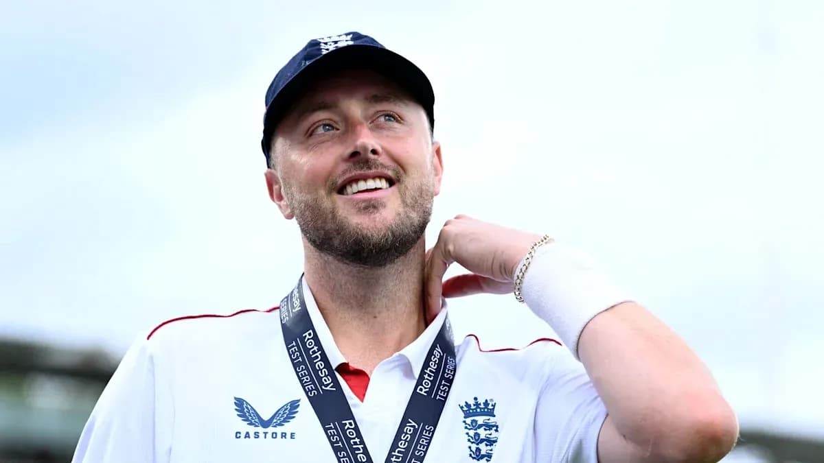 Cricketer wearing England jersey with medal around neck