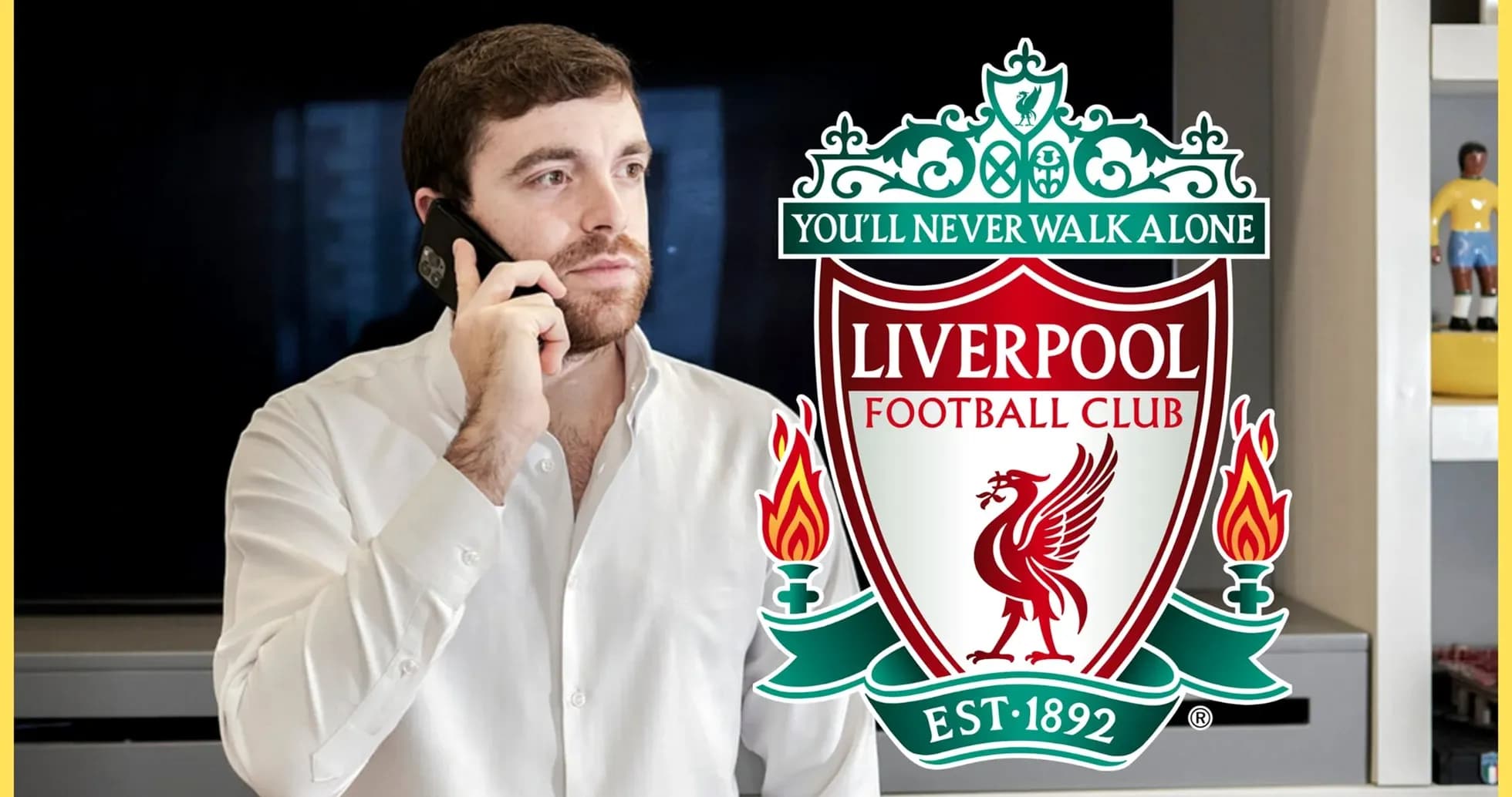Man on phone with Liverpool FC logo in background