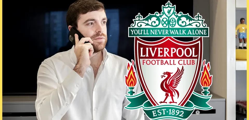 Man on phone with Liverpool FC logo in background