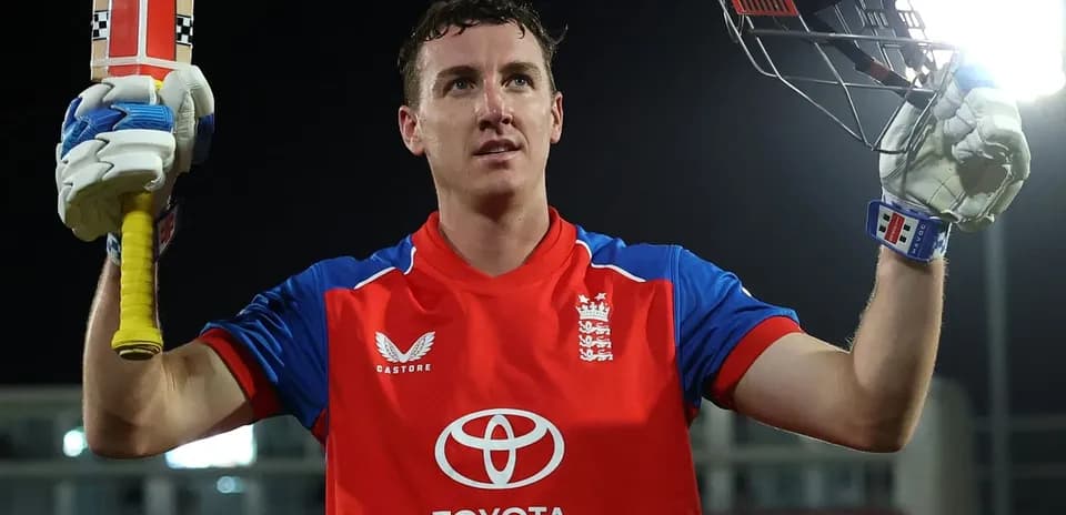 Batsman celebrating with bat raised after scoring
