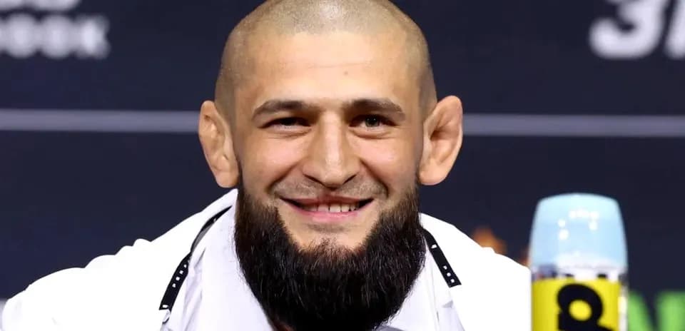Fighter smiling at press conference table