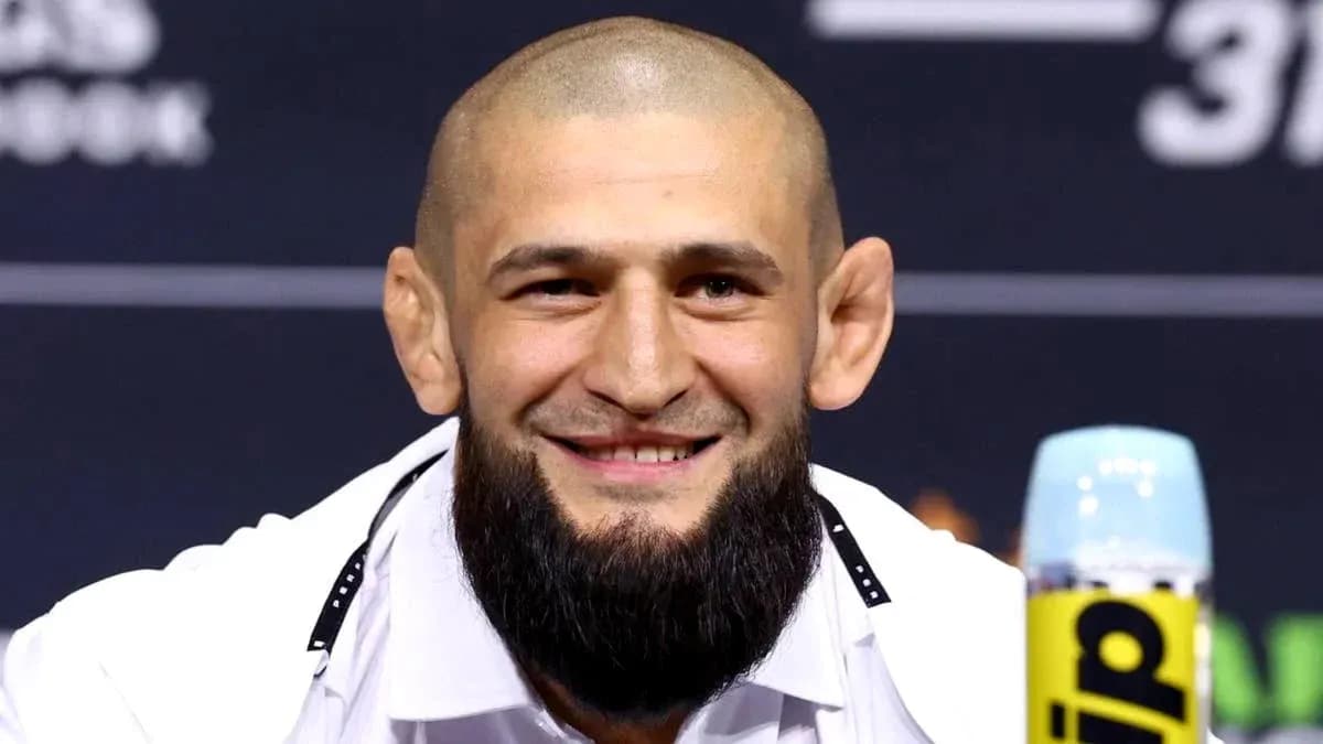Fighter smiling at press conference table