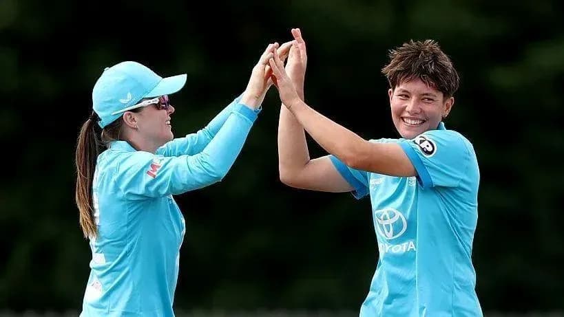Two players celebrating with high-five on field
