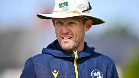 Cricket coach wearing a hat during training session