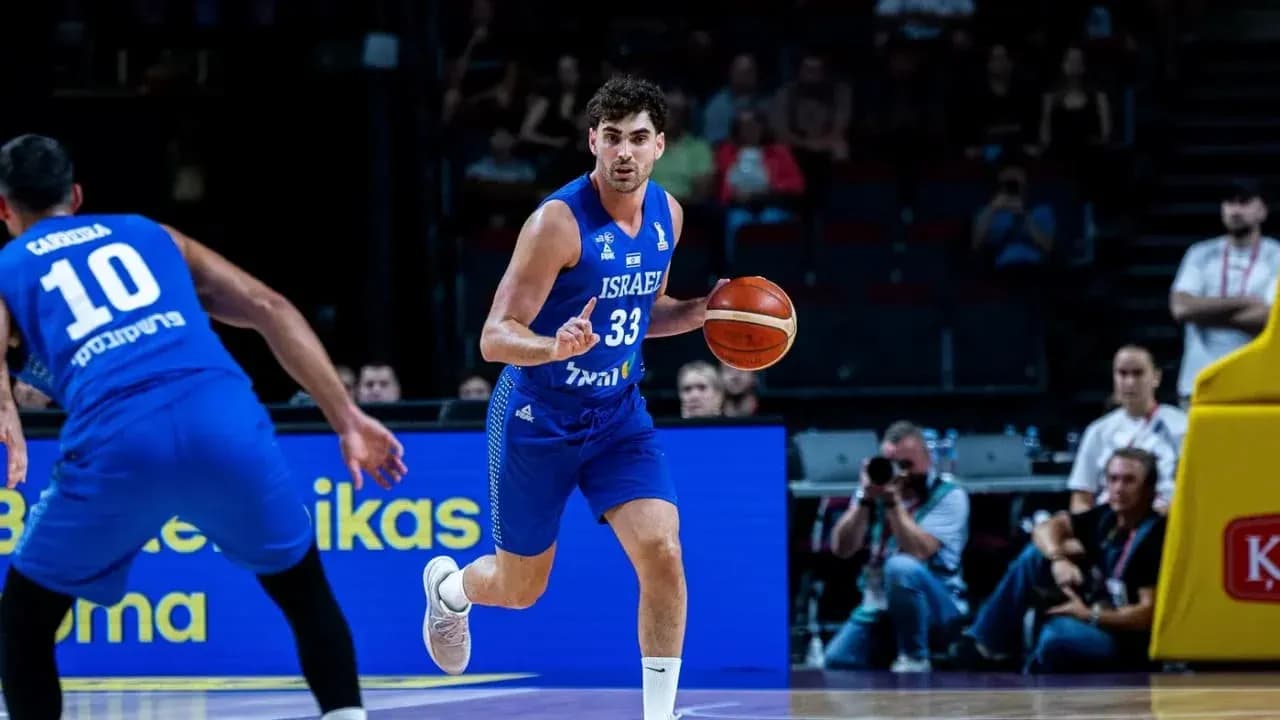 Israeli player dribbling basketball during a game
