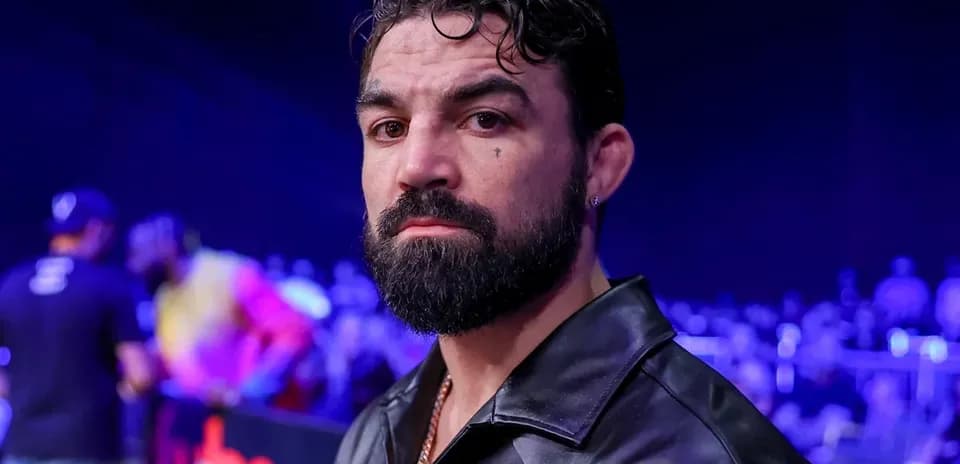 Man with beard and leather jacket in arena