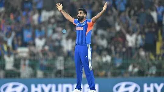 Cricketer celebrating with arms raised during match
