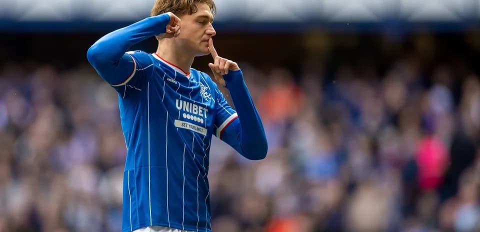 Player celebrating with a shushing gesture after scoring