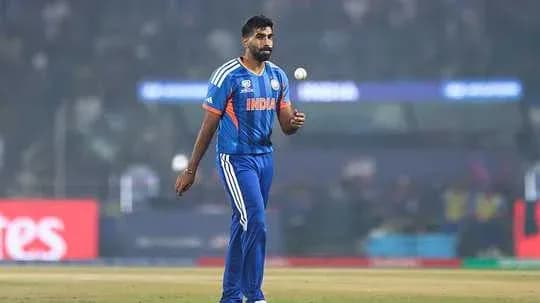 Bowler walking on field holding a cricket ball