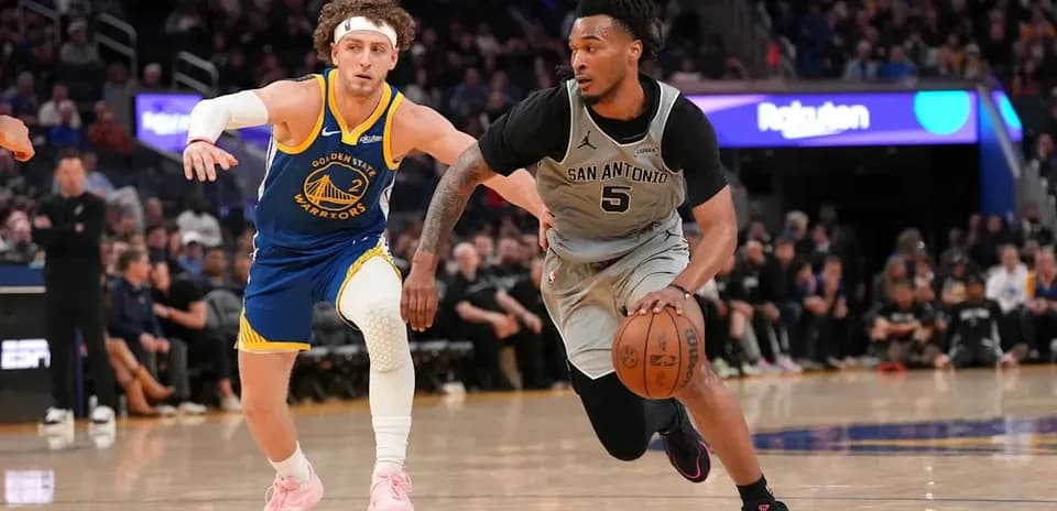 San Antonio player dribbling past Golden State defender