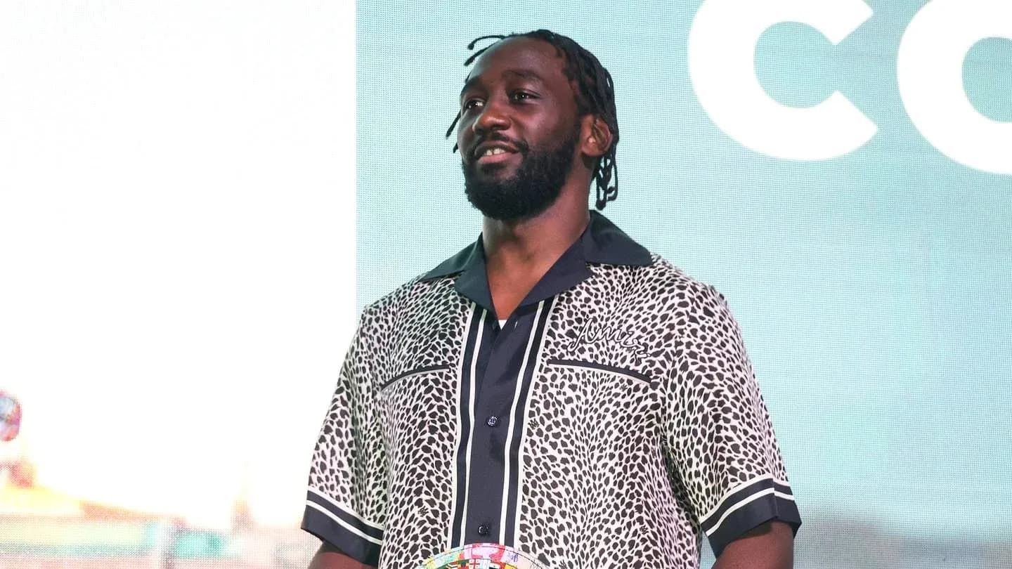 Man in patterned shirt holding a trophy
