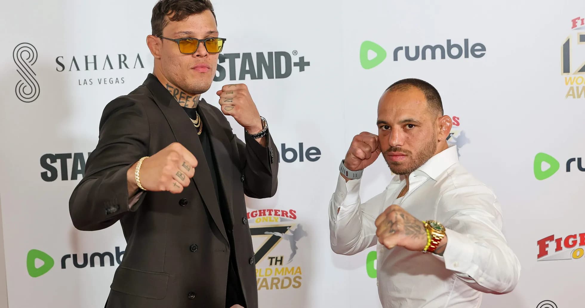 Two fighters posing with clenched fists at event