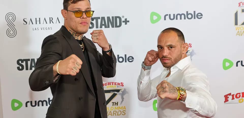 Two fighters posing with clenched fists at event