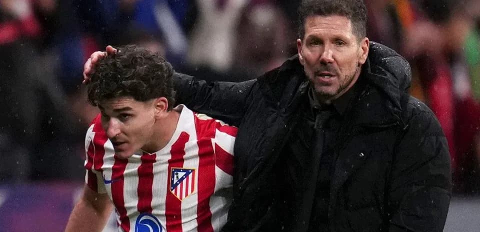 Atletico Madrid player being assisted by coach