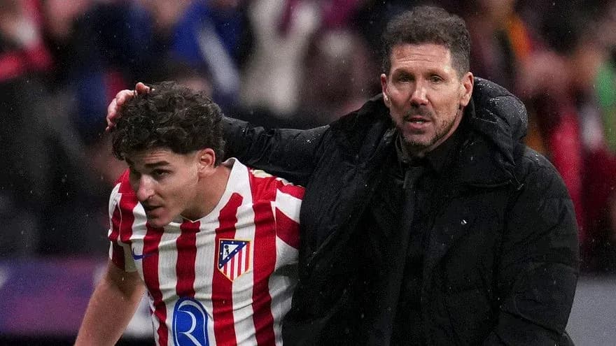Atletico Madrid player being assisted by coach