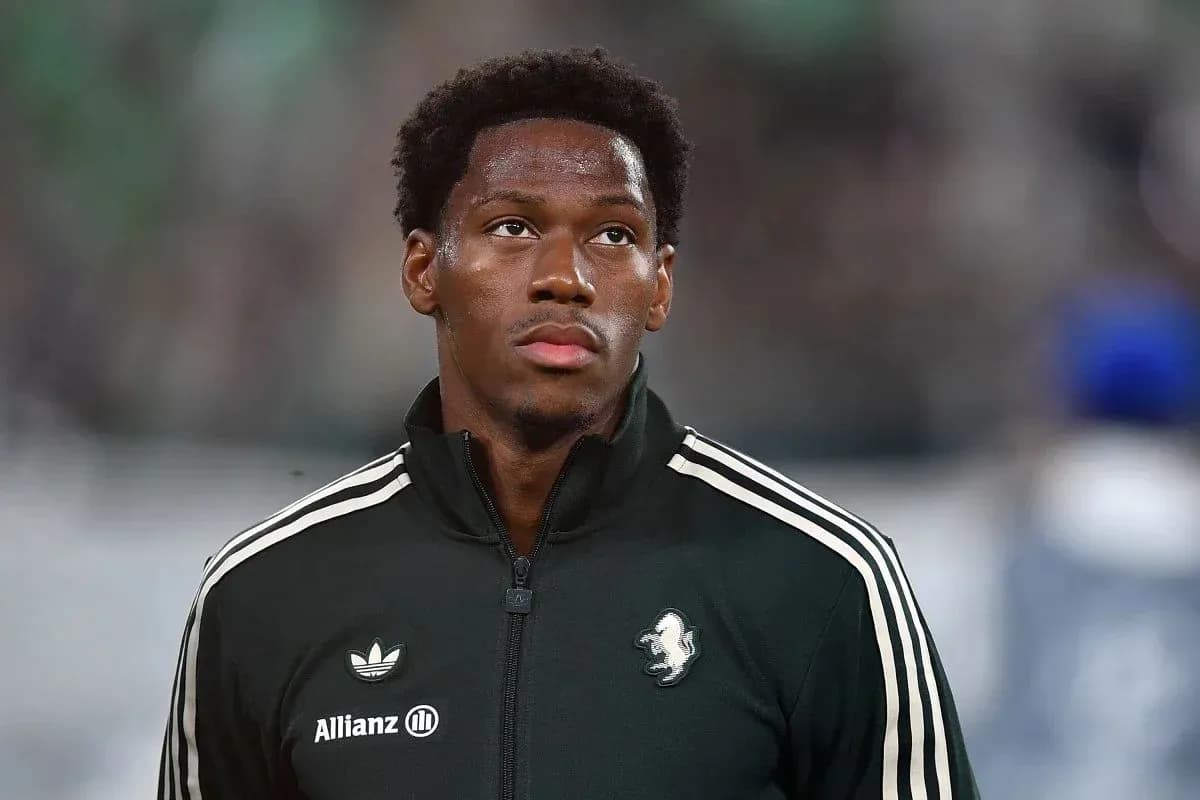 Player in warm-up jacket on field before match