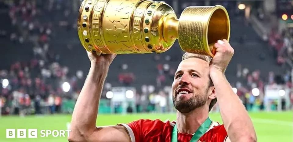 Player holding trophy aloft after winning match