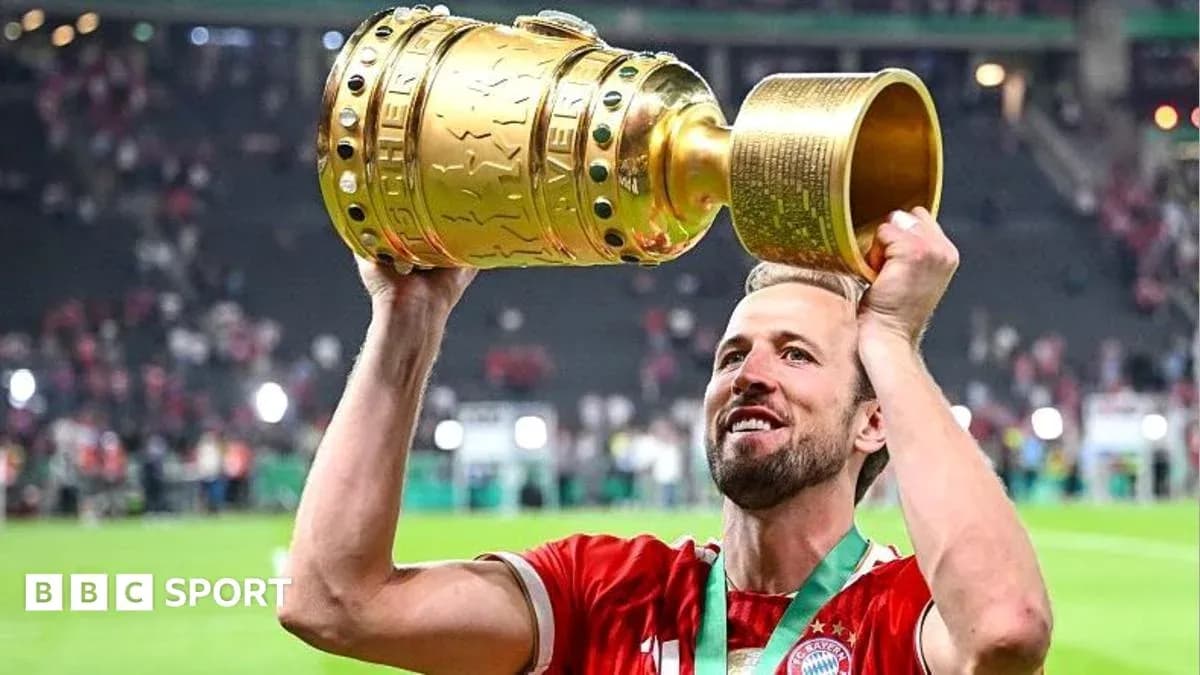 Player holding trophy aloft after winning match