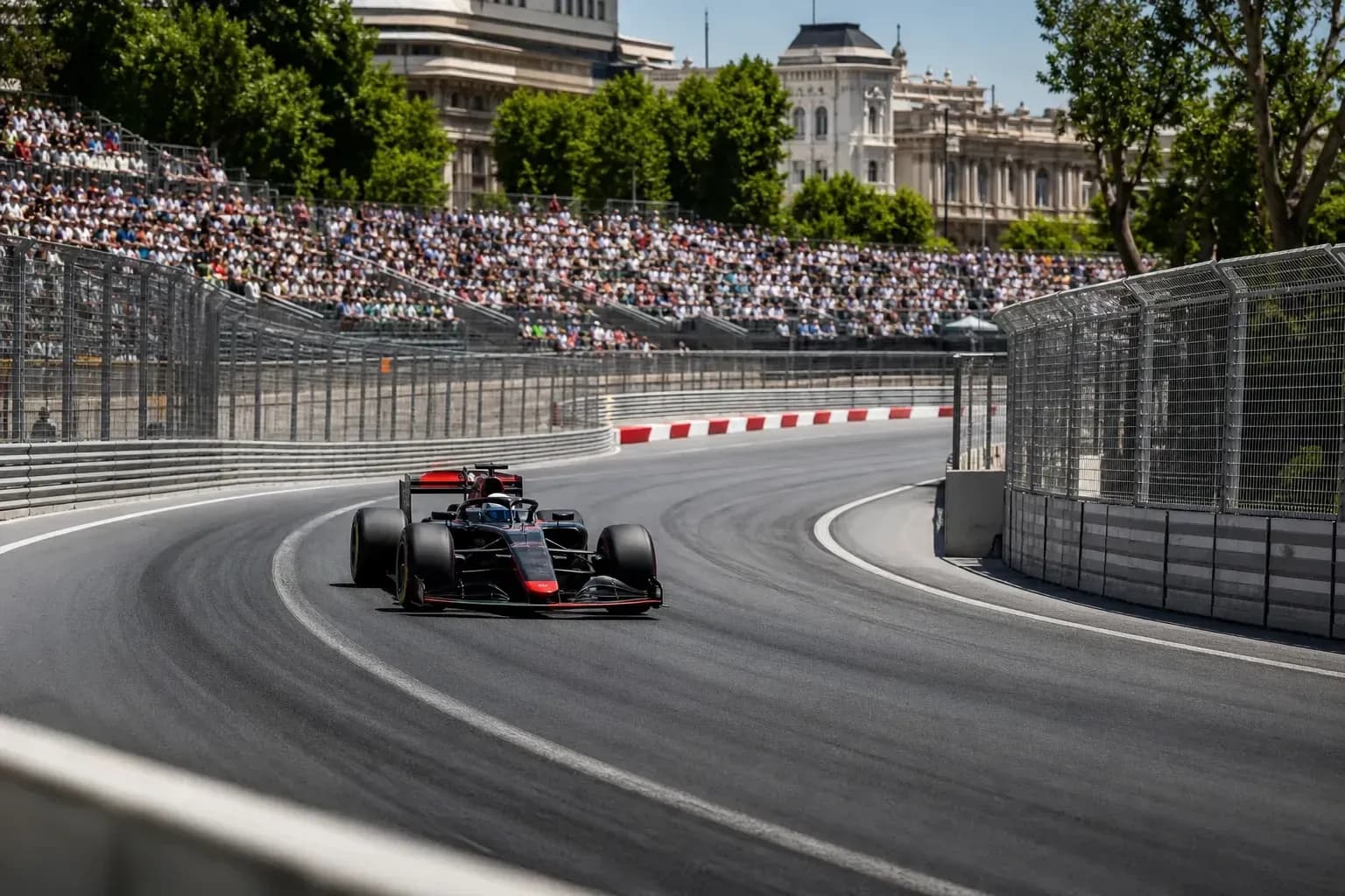 Formula 1 car rounding a curve on racetrack