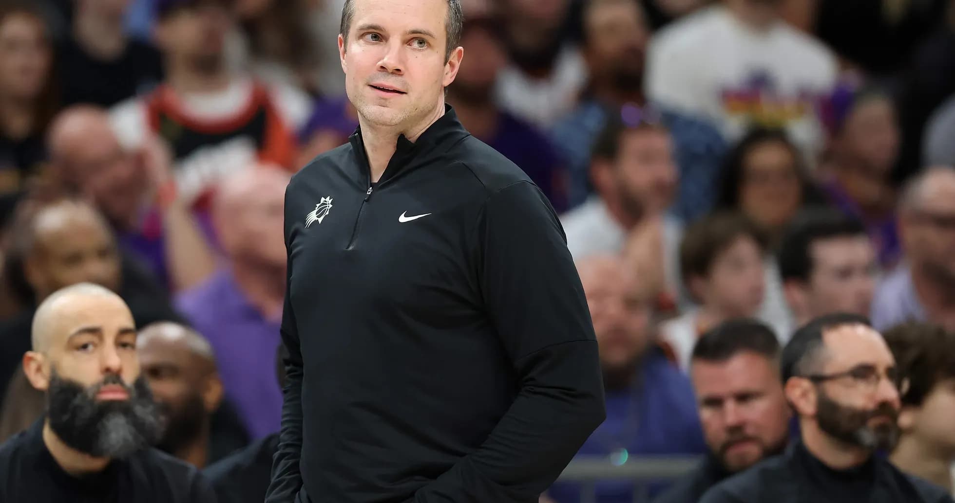 Coach observing game from sidelines during match
