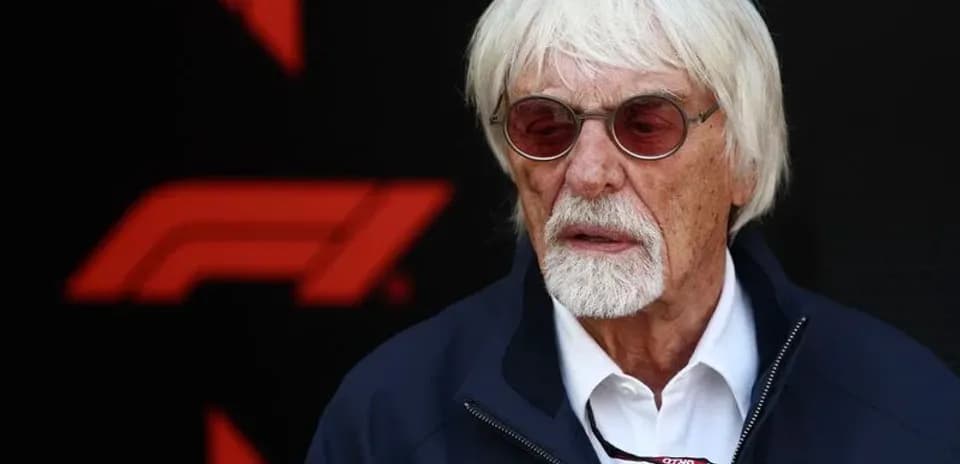Man with white hair and sunglasses at event