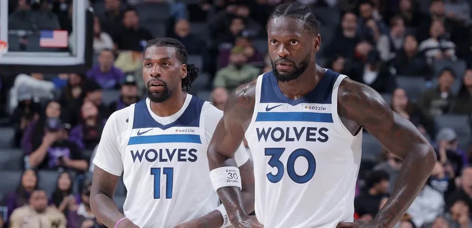 Two players in Minnesota Timberwolves jerseys on court