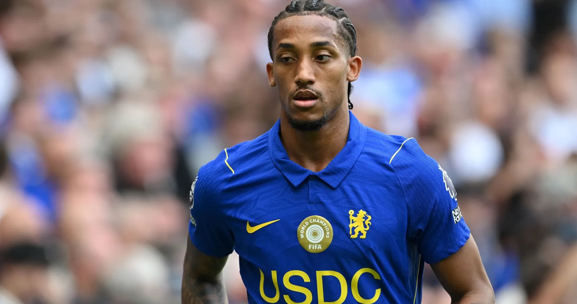 Player in blue Chelsea kit walking on field