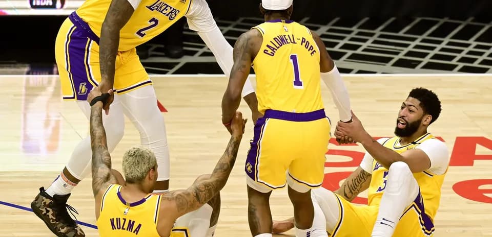 Los Angeles Lakers players assisting teammates on court