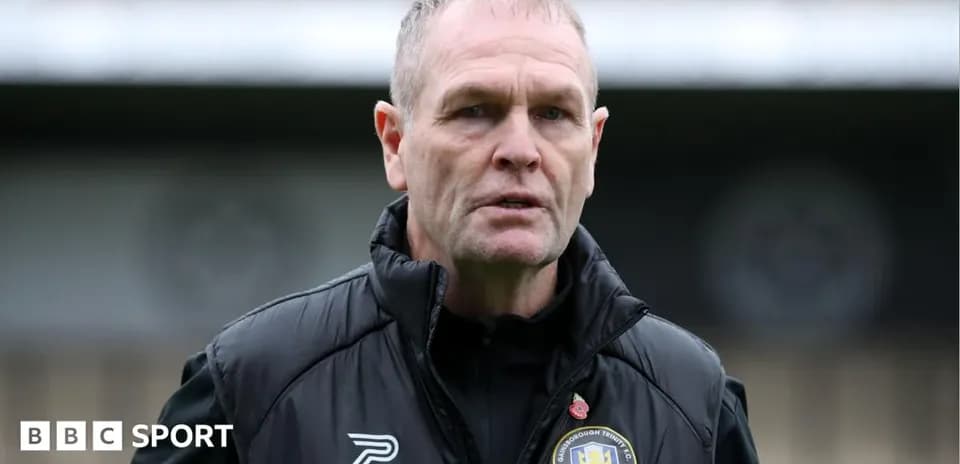 Manager standing on the pitch before a match