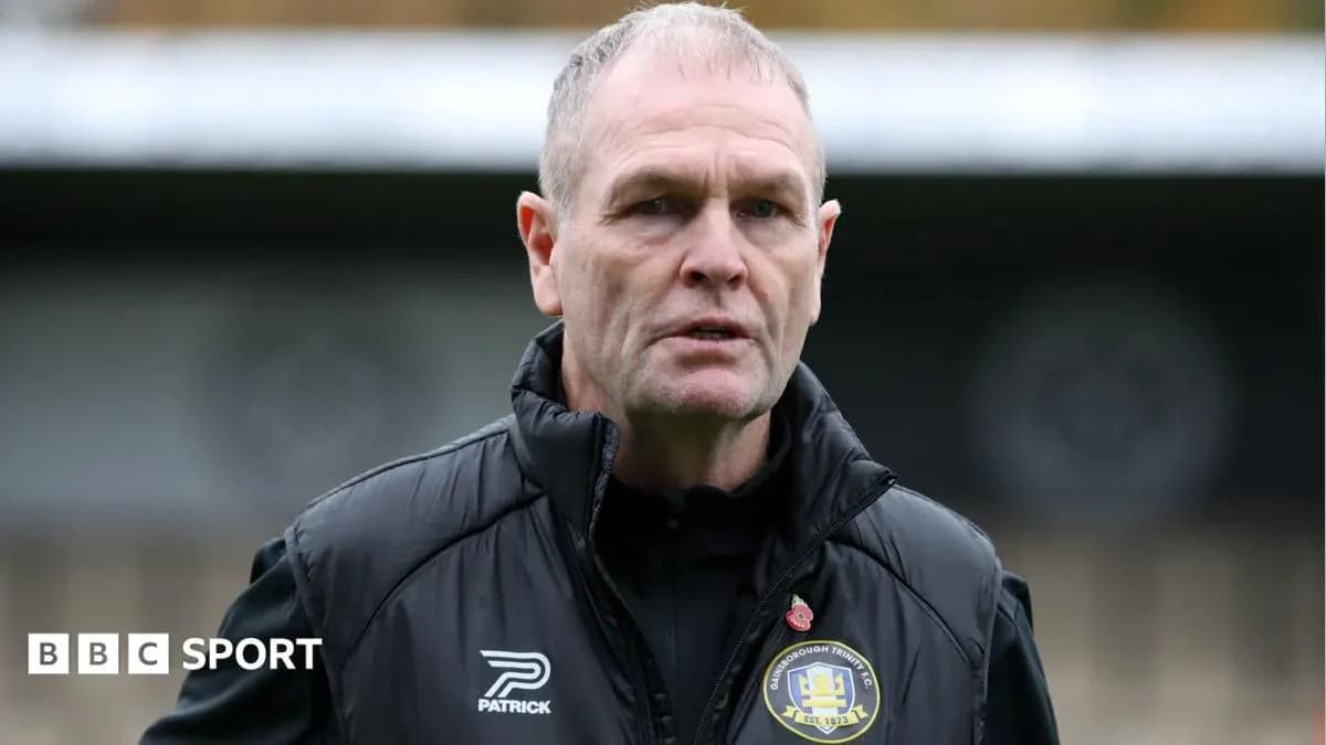 Manager standing on the pitch before a match