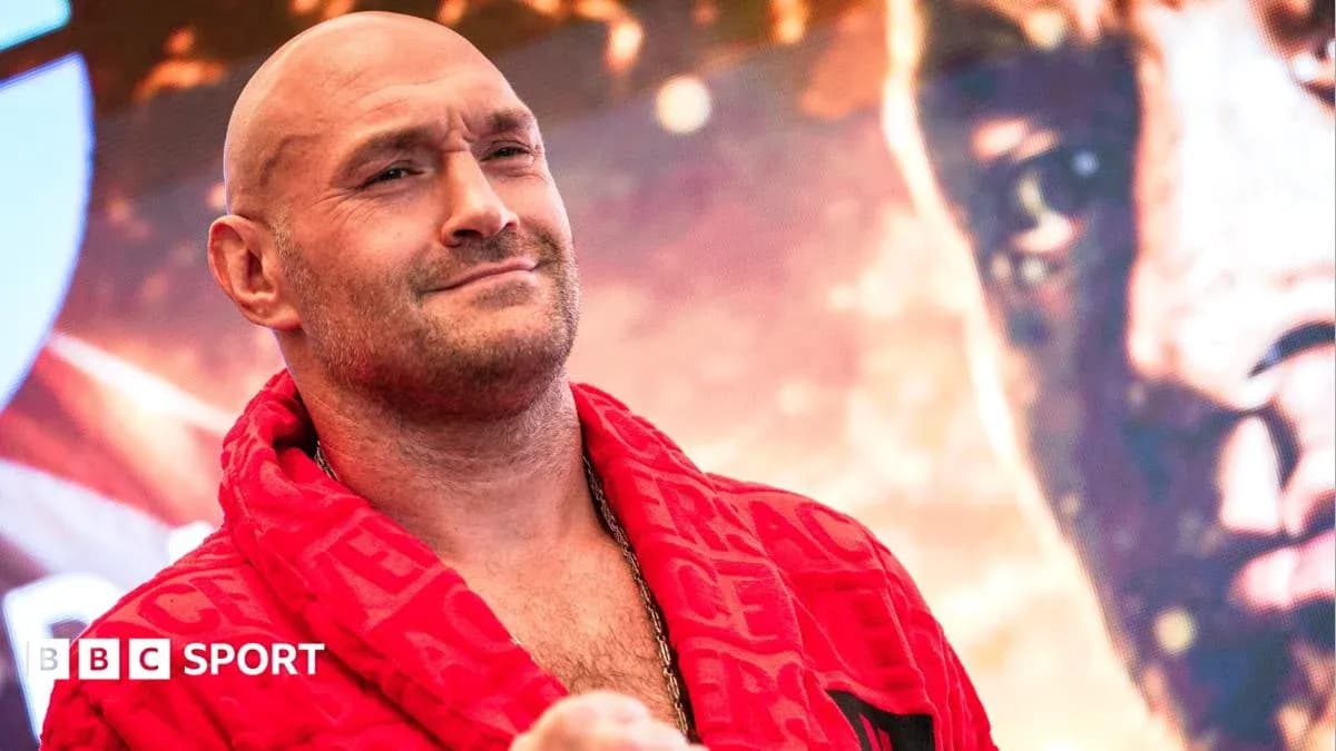 Boxer posing in red robe at promotional event