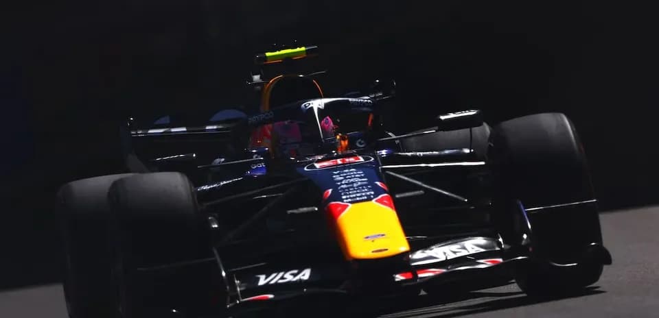 Formula 1 car racing on track in sunlight