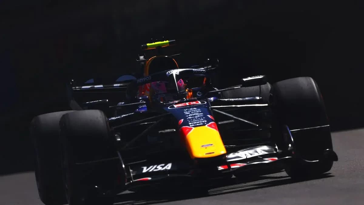 Formula 1 car racing on track in sunlight