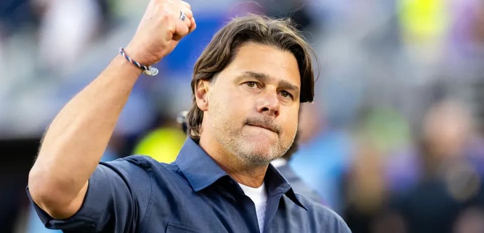 Coach raising fist in celebration on sidelines