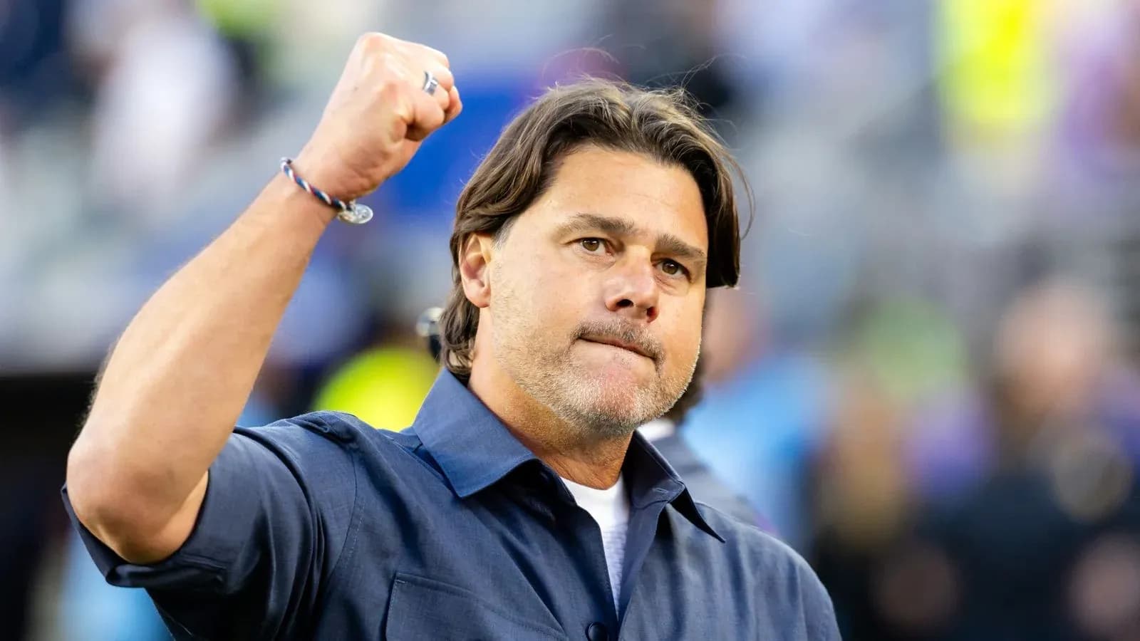 Coach raising fist in celebration on sidelines