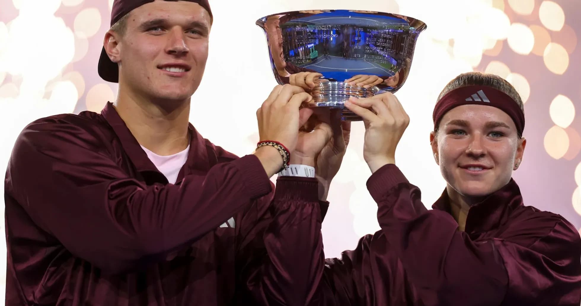 Players celebrating with trophy after tournament victory