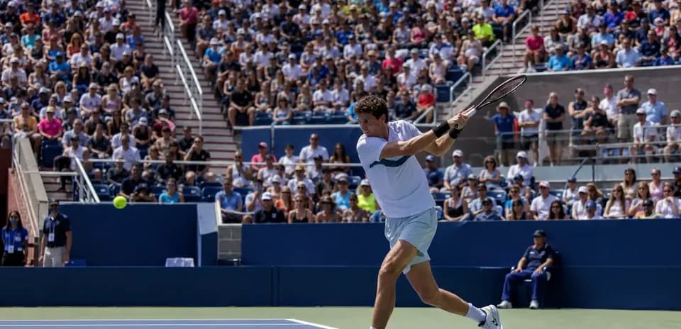 Player hitting a backhand during a tennis match