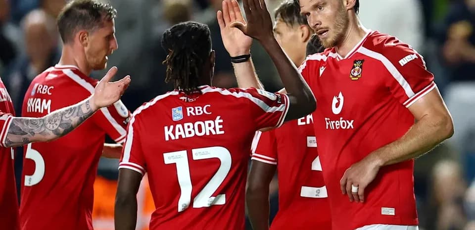 Players celebrating a goal on the field