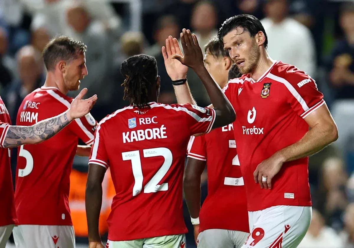 Players celebrating a goal on the field
