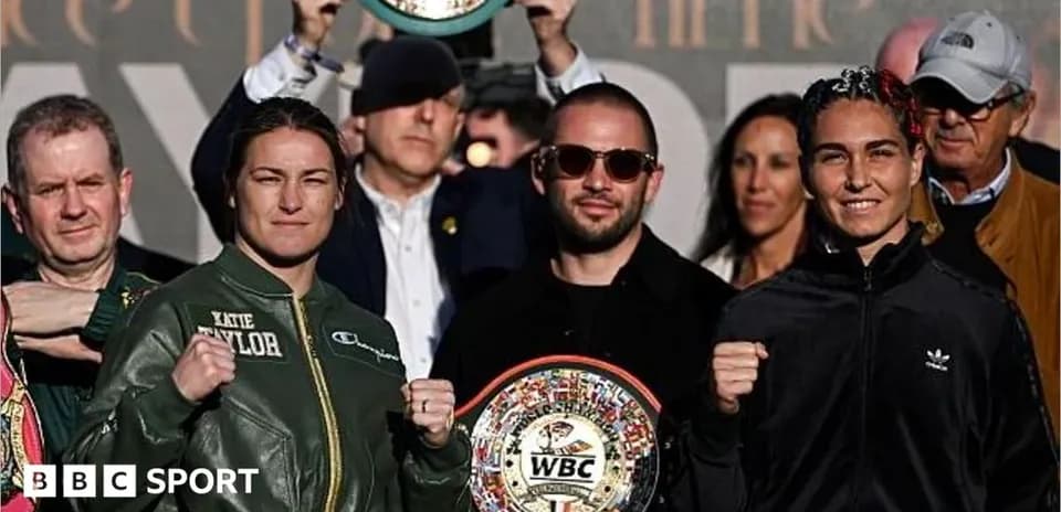 Katie Taylor and opponent posing with WBC belts