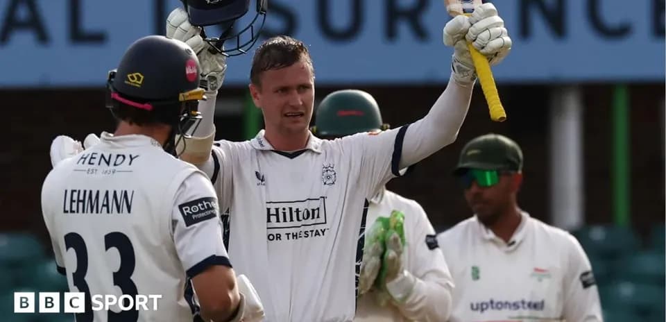 Batsman celebrating a century with teammates nearby