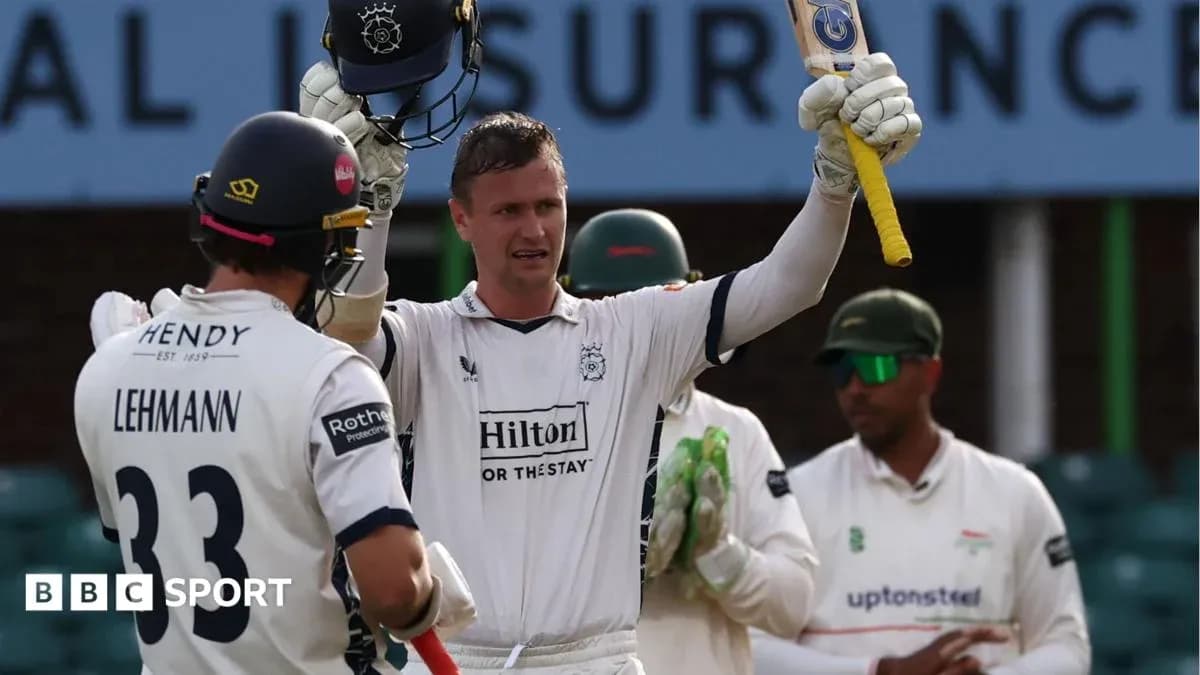 Batsman celebrating a century with teammates nearby