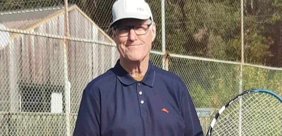 Man holding a tennis racket on court