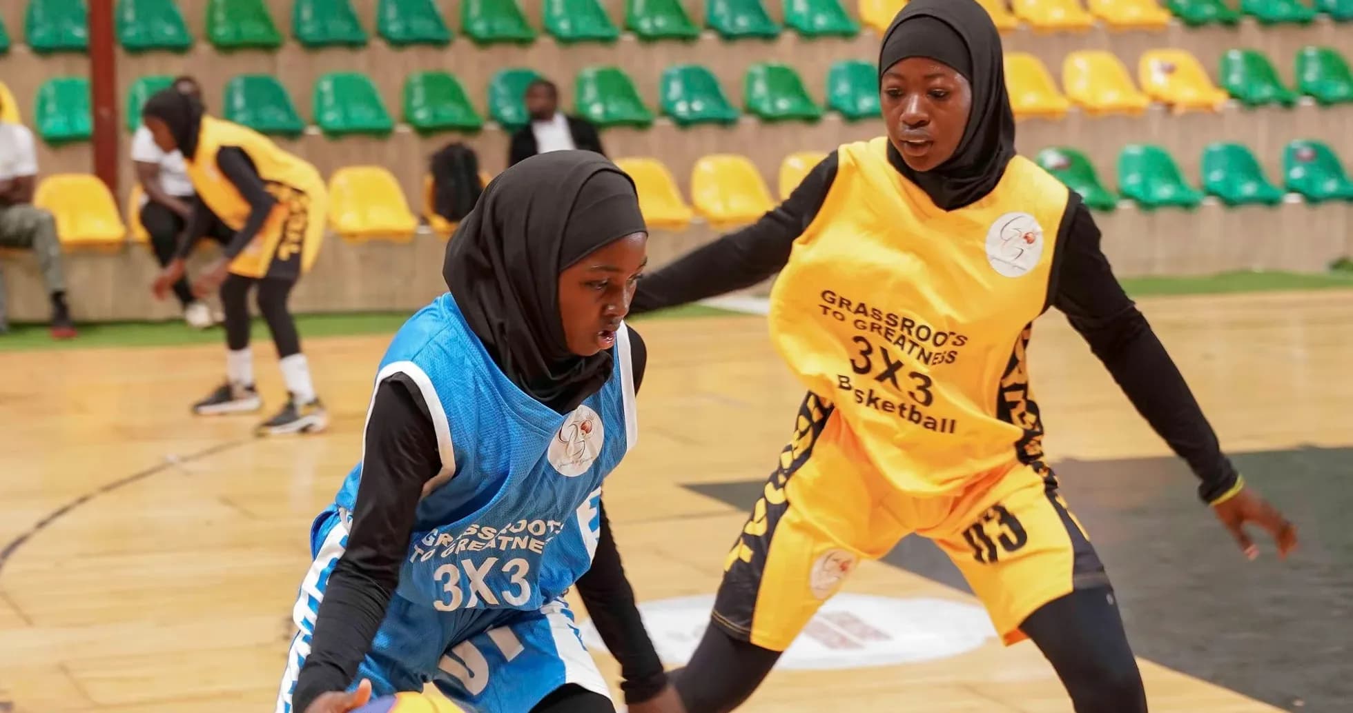 Two female players competing in a basketball match