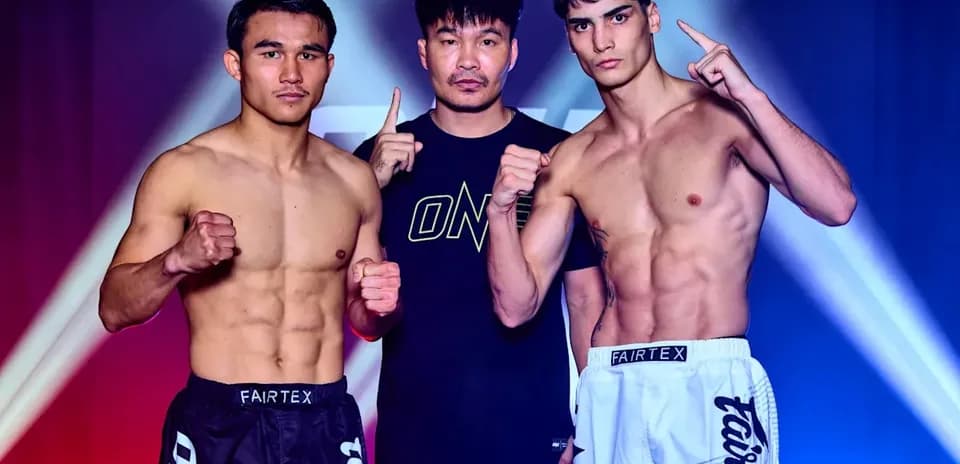 Two fighters posing with trainer before match