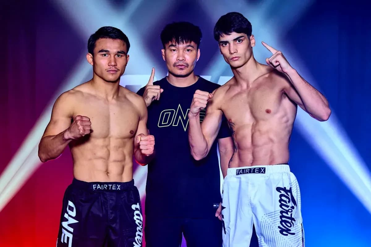 Two fighters posing with trainer before match