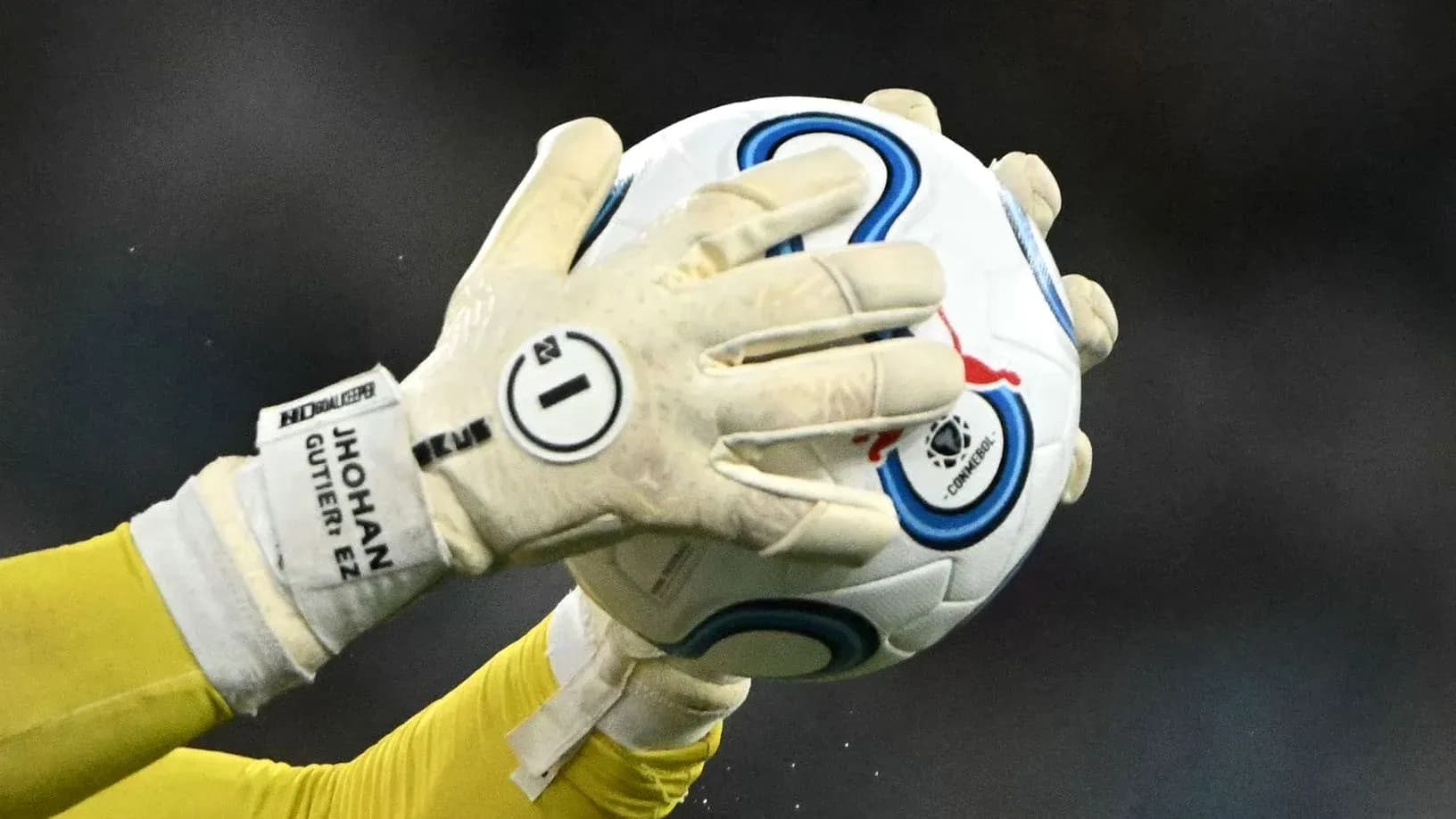 Goalkeeper catching a soccer ball during play